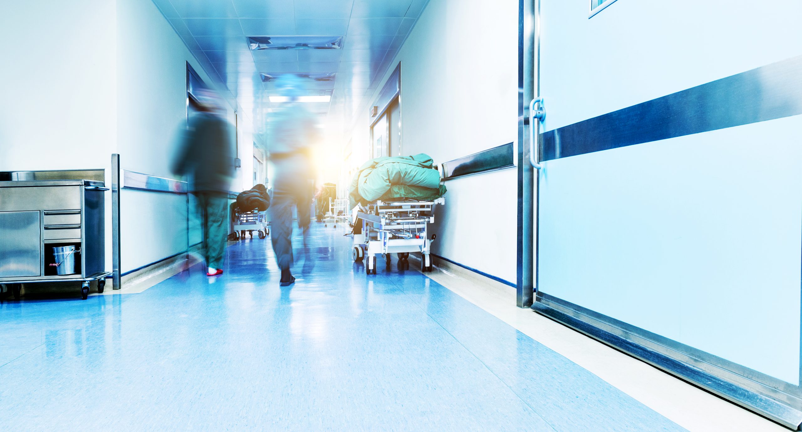 Doctors,Or,Nurses,Walking,In,Hospital,Hallway,,Blurred,Motion.